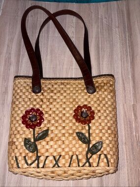 Woven Straw Tote with Red & Orange Floral Accents and Brown Straps